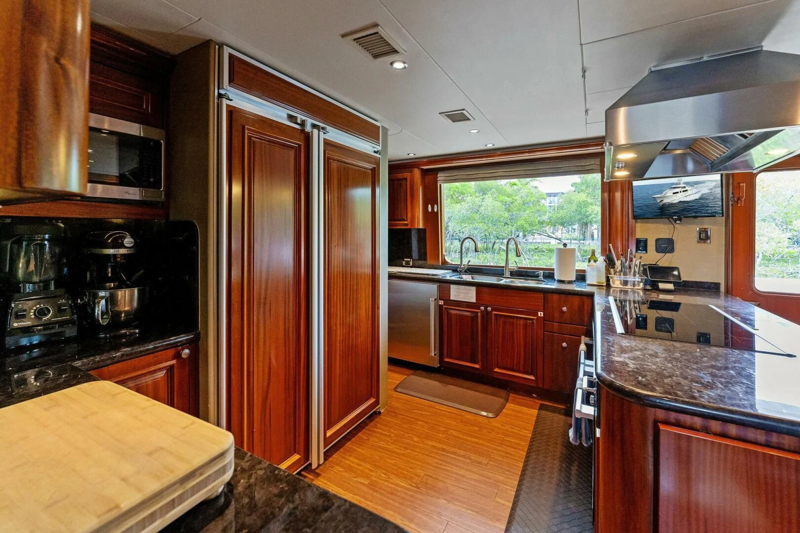 a kitchen with wooden cabinets aboard ANTARES Yacht for Sale