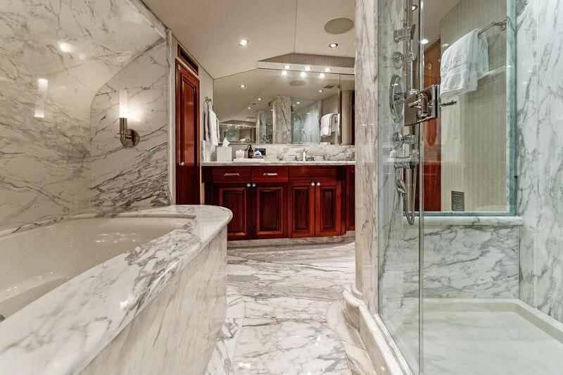 a bathroom with a tub and shower aboard ANTARES Yacht for Sale