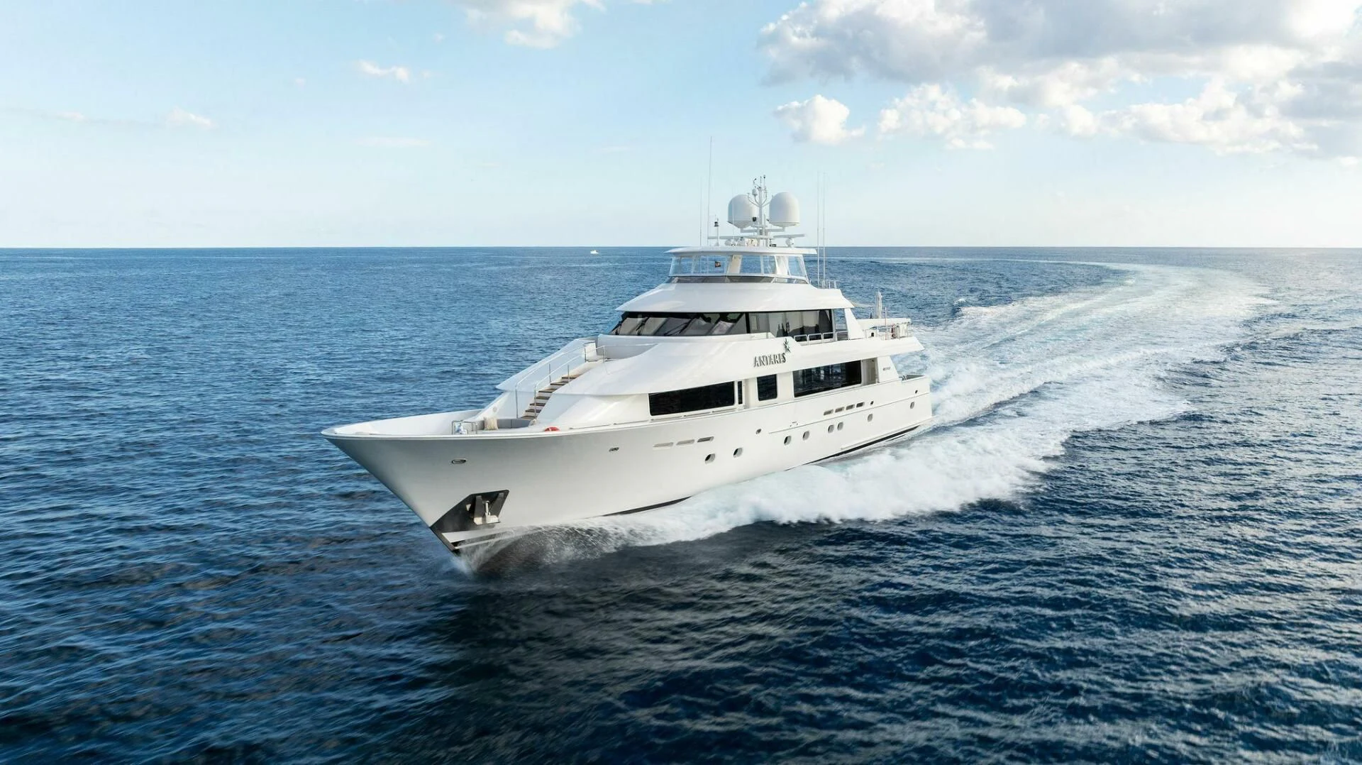 a white yacht in the water aboard ANTARES Yacht for Sale