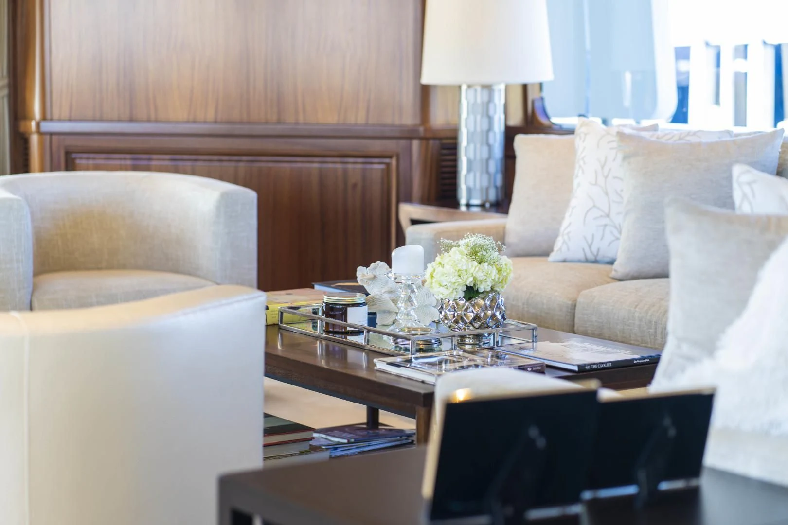 a living room with a coffee table and couches aboard ANTARES Yacht for Sale