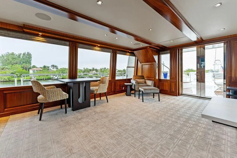 a large open room with a table and chairs aboard ANTARES Yacht for Sale