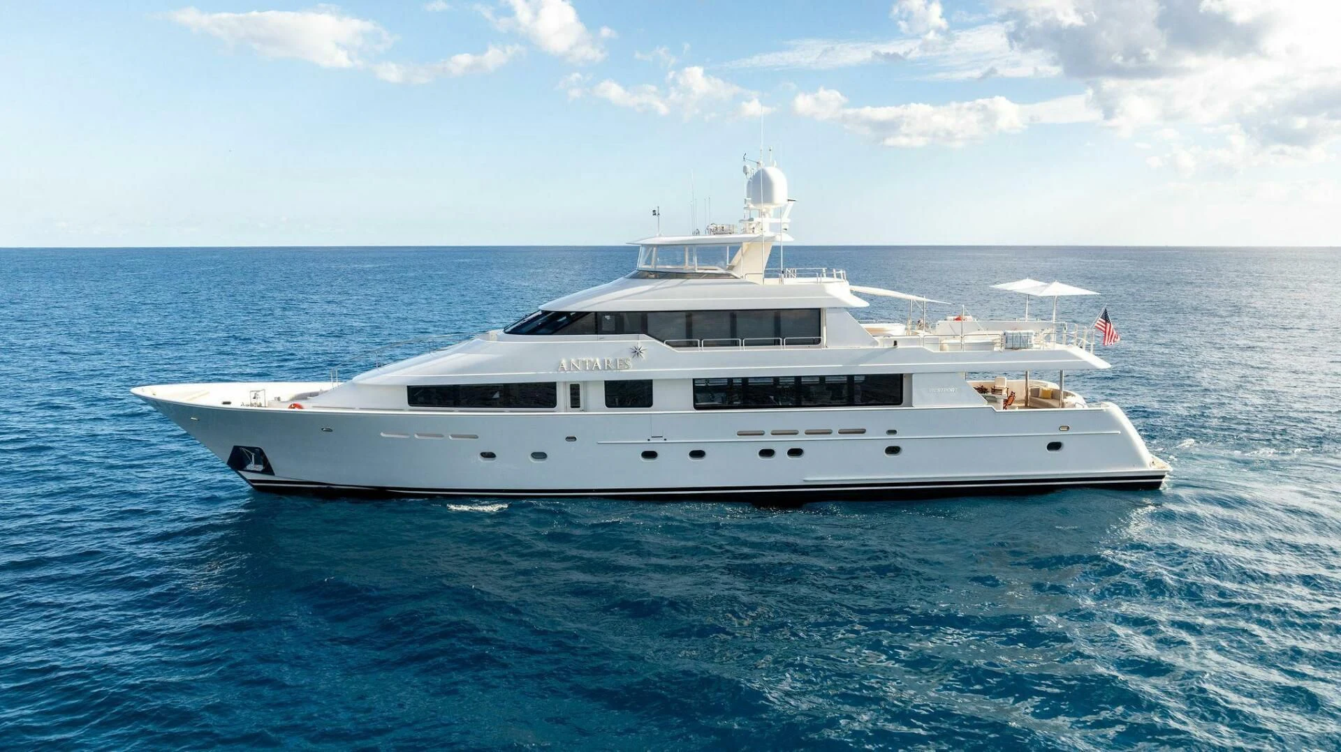 a white yacht in the water aboard ANTARES Yacht for Sale