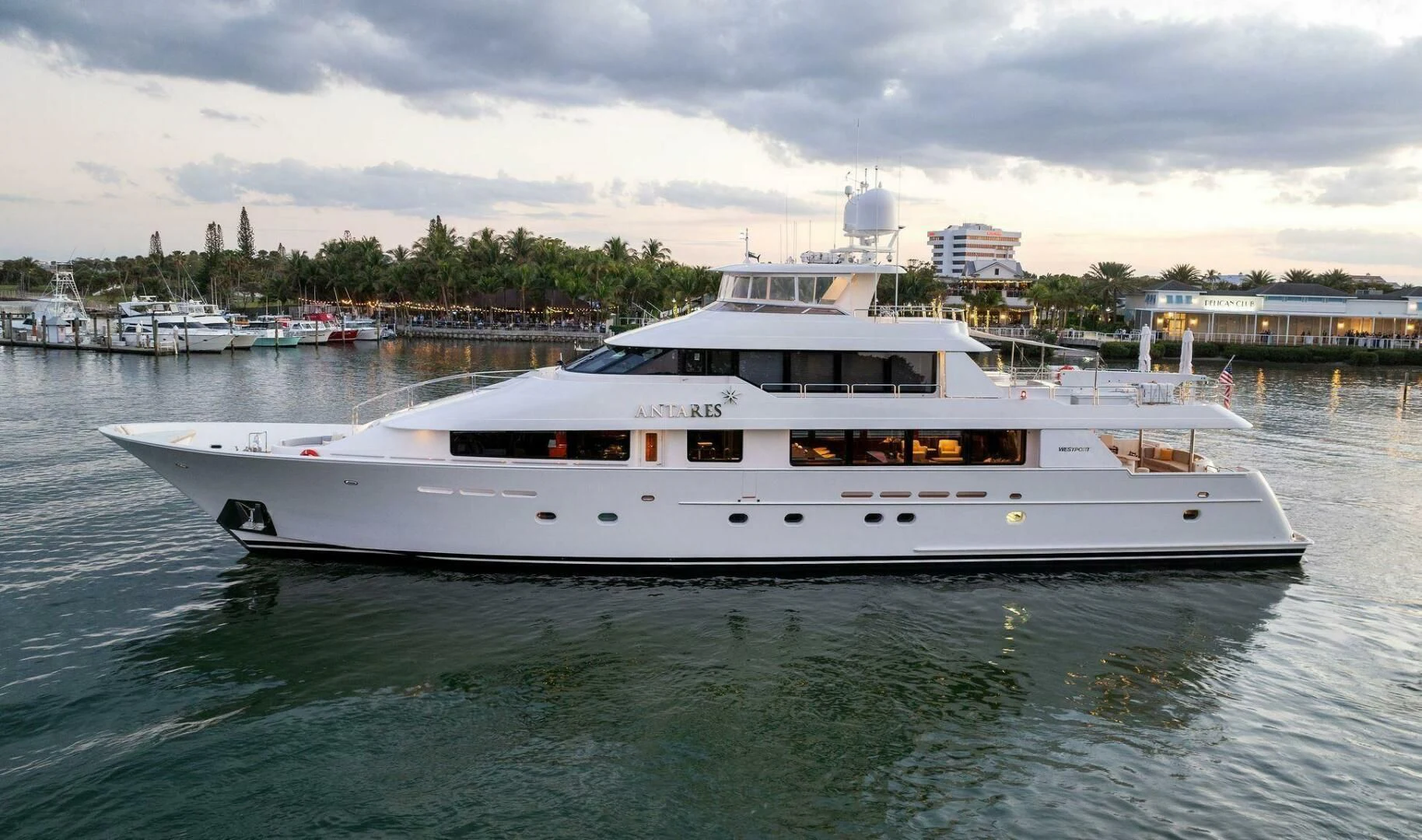 a white yacht in a harbor aboard ANTARES Yacht for Sale