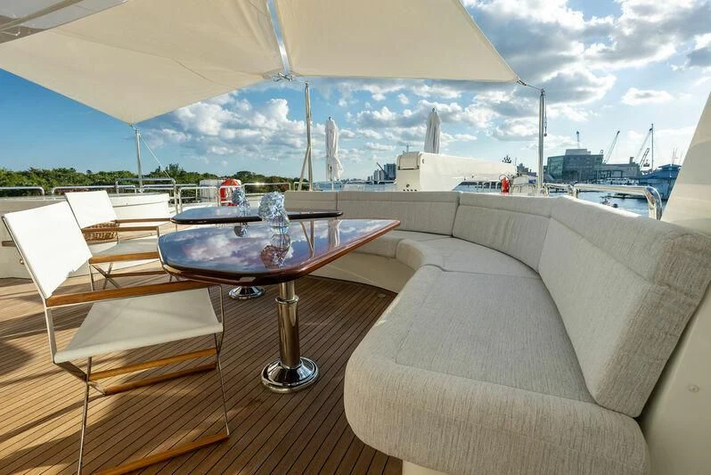 a table and chairs on a patio aboard ANTARES Yacht for Sale