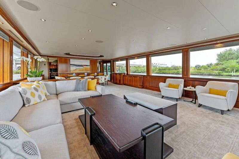 a living room with a table and couches aboard ANTARES Yacht for Sale