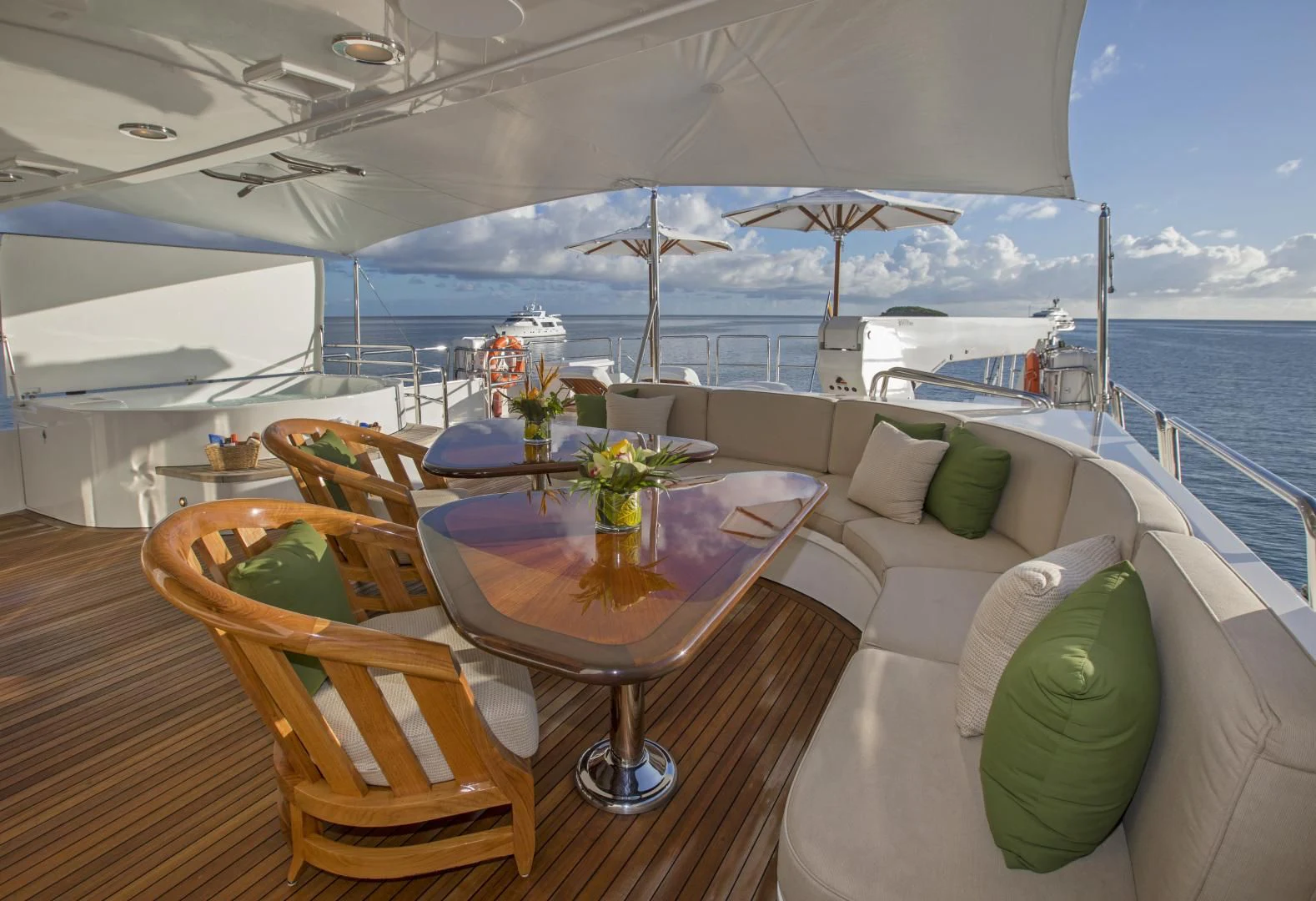 a table and chairs on a deck overlooking a large body of water aboard ANTARES Yacht for Sale