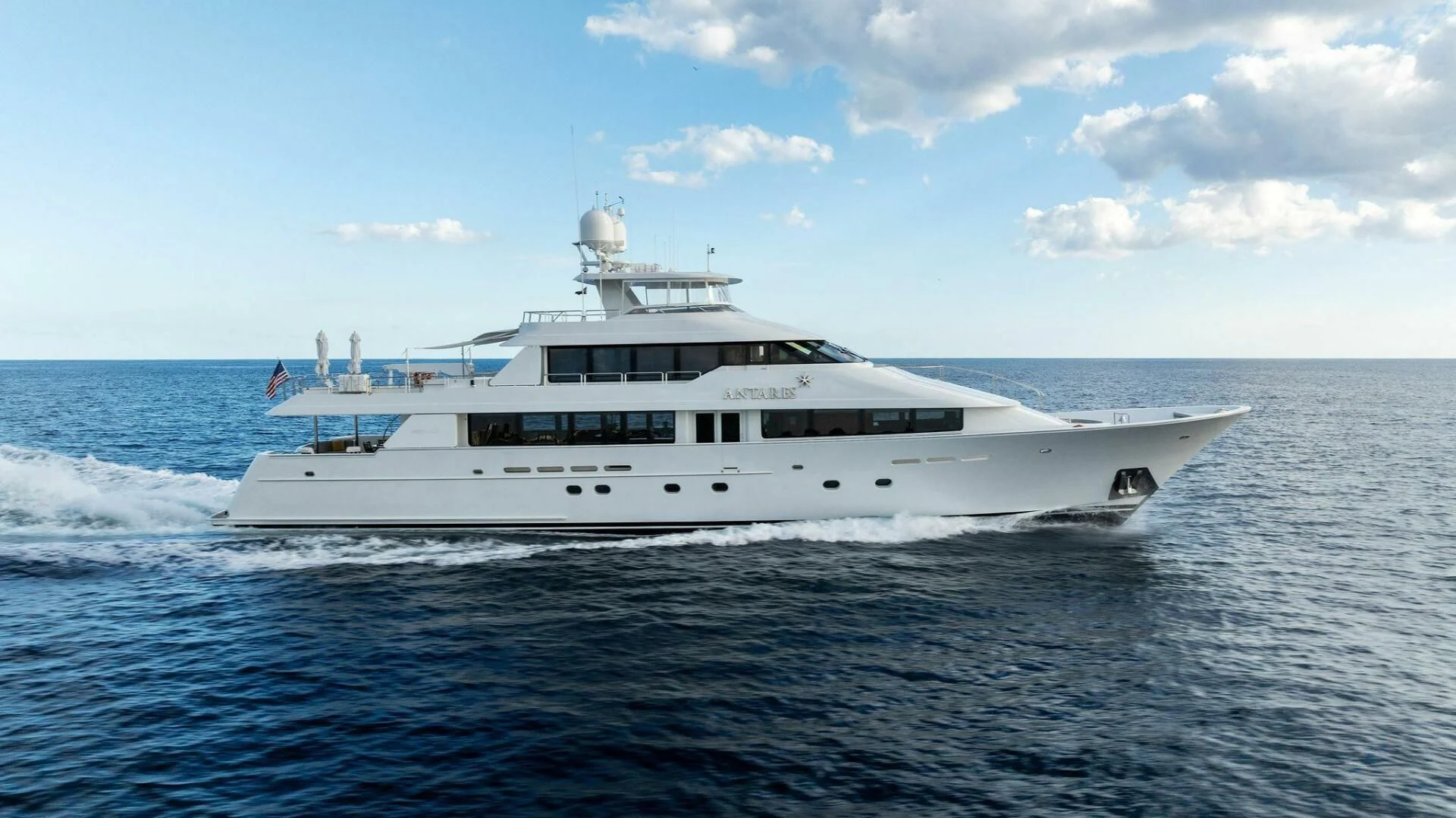 a large white boat in the water aboard ANTARES Yacht for Sale