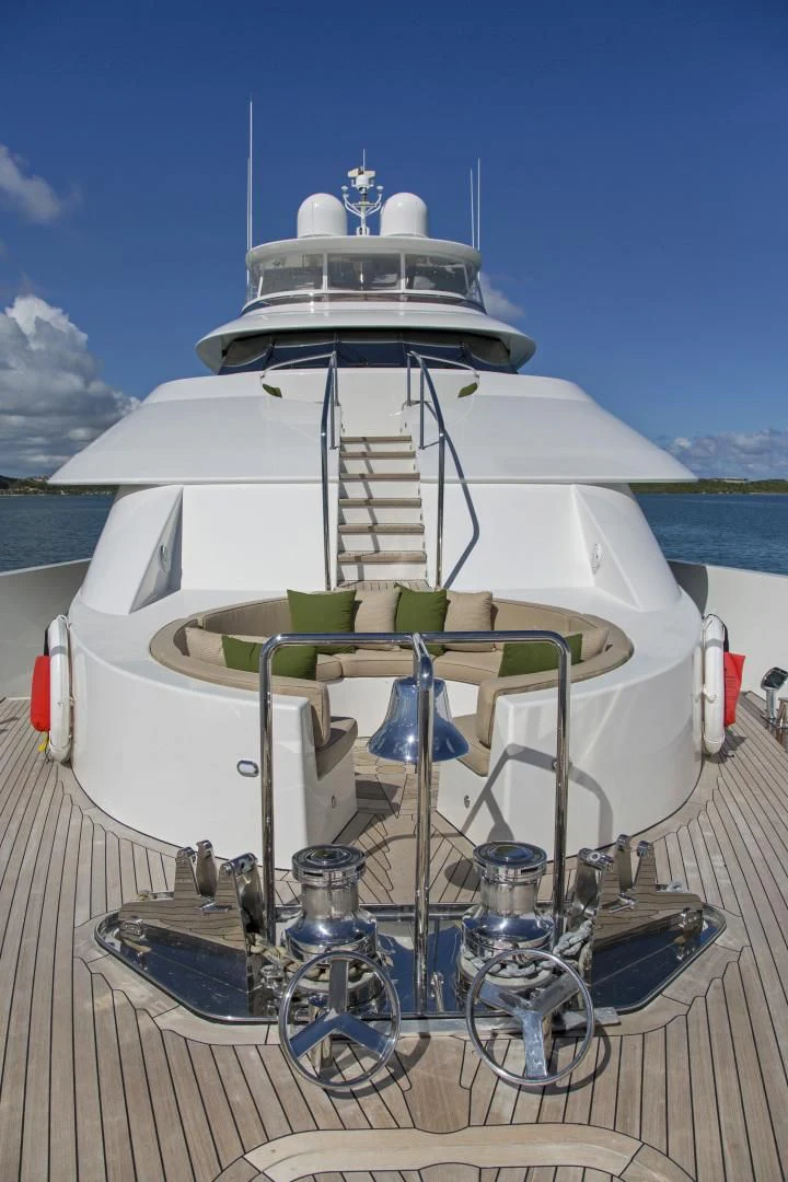 a white boat with green and blue trim on a deck aboard ANTARES Yacht for Sale