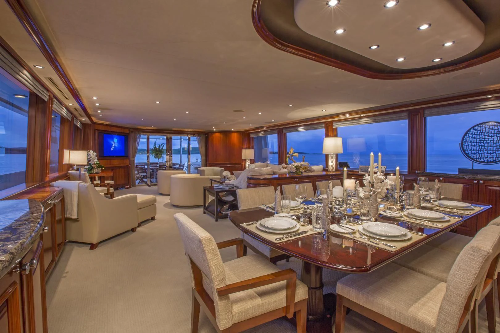 a large living room with a large dining table and chairs aboard ANTARES Yacht for Sale