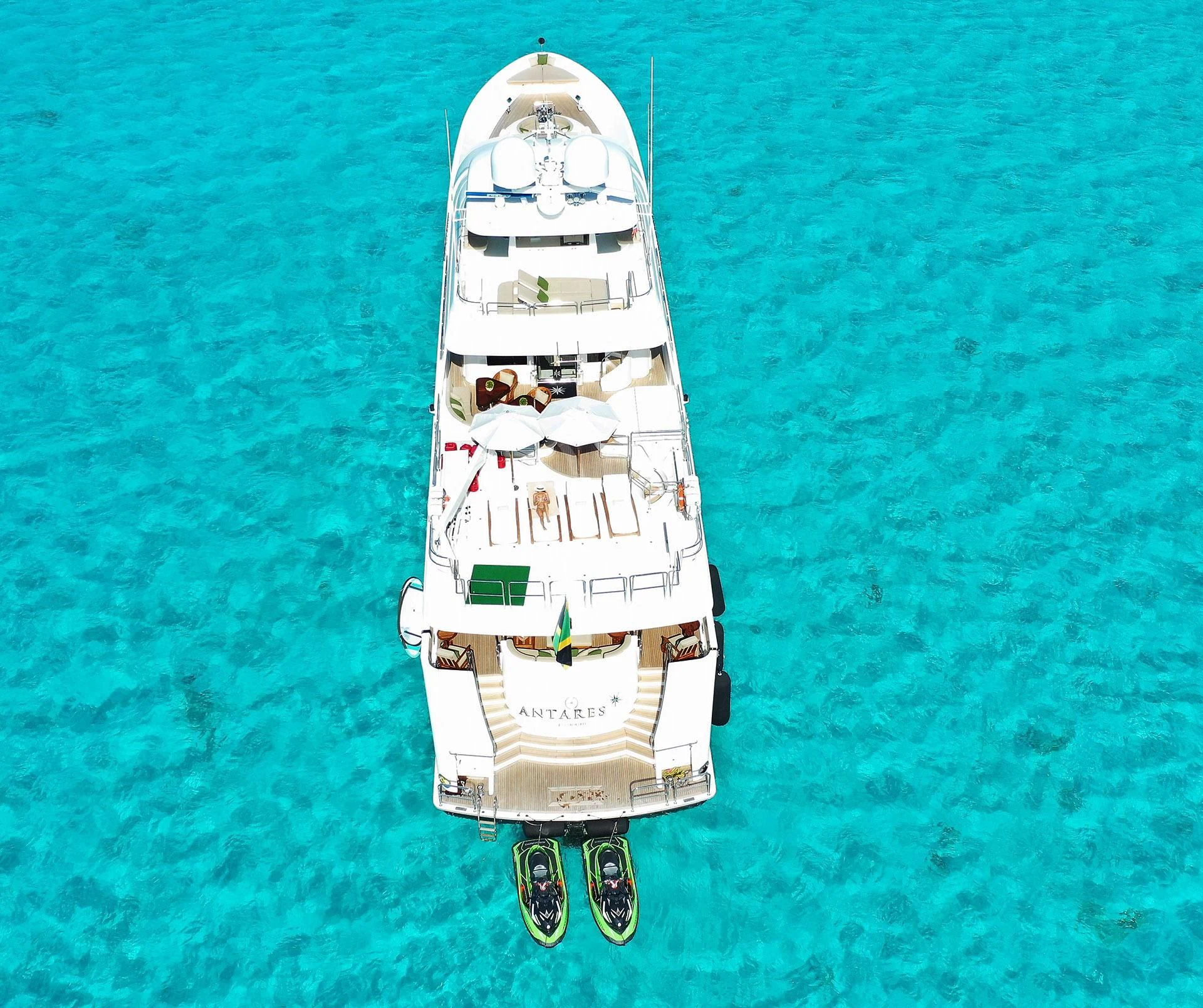a small white boat on a body of water aboard ANTARES Yacht for Sale