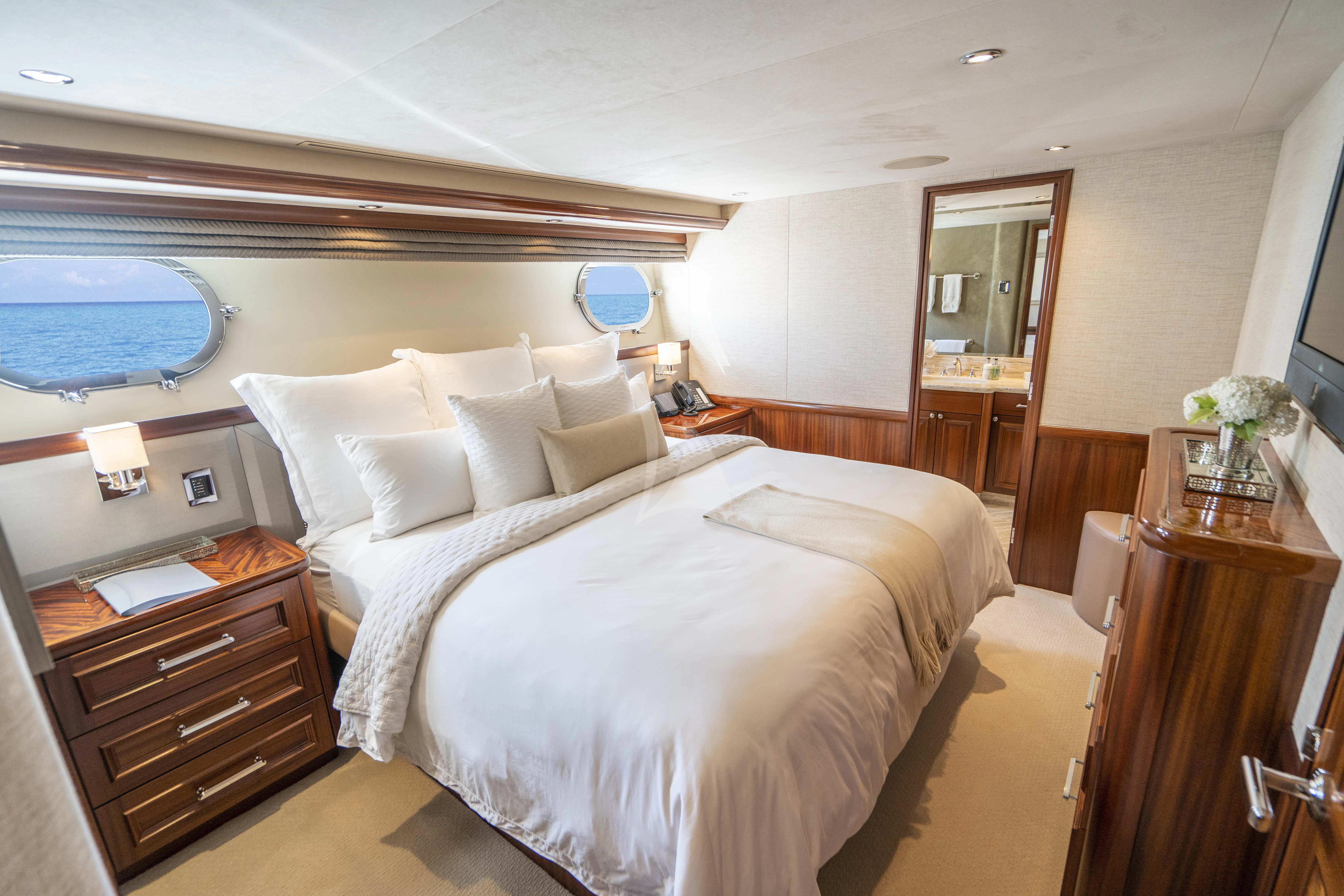 a hotel room with a bed and a dresser aboard ANTARES Yacht for Sale