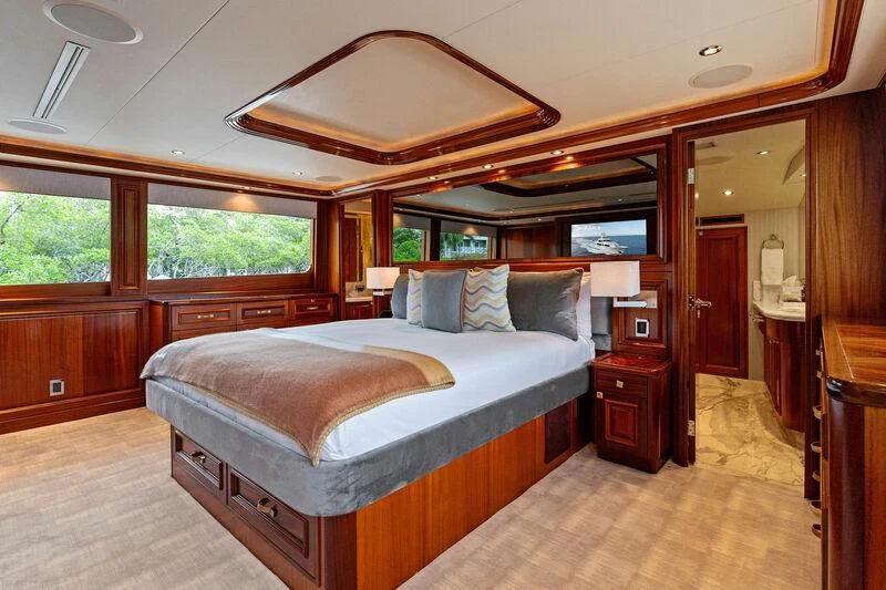 a bedroom with a bed and a fan aboard ANTARES Yacht for Sale