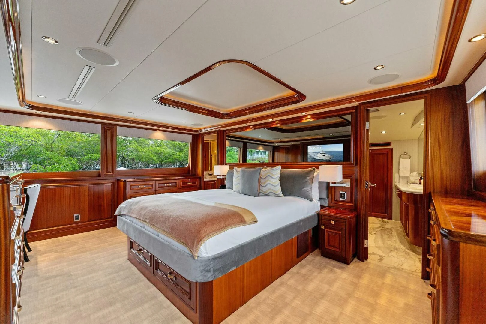 a bedroom with a bed and a wood door aboard ANTARES Yacht for Sale