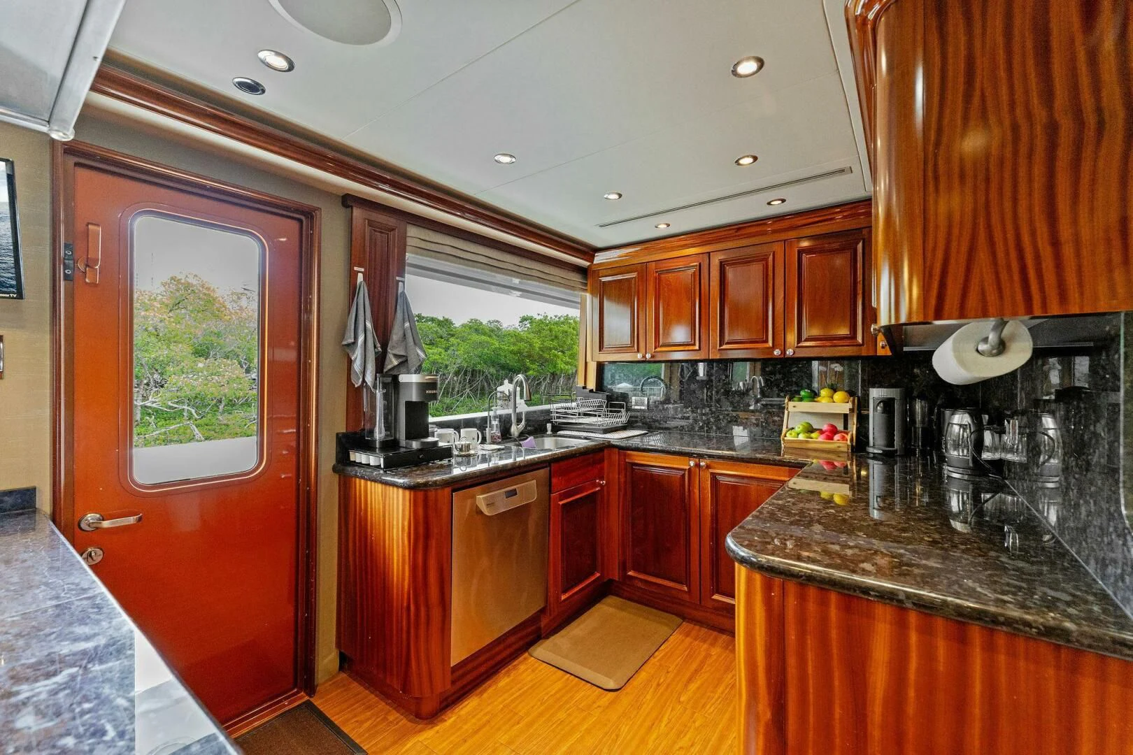a kitchen with wooden cabinets aboard ANTARES Yacht for Sale