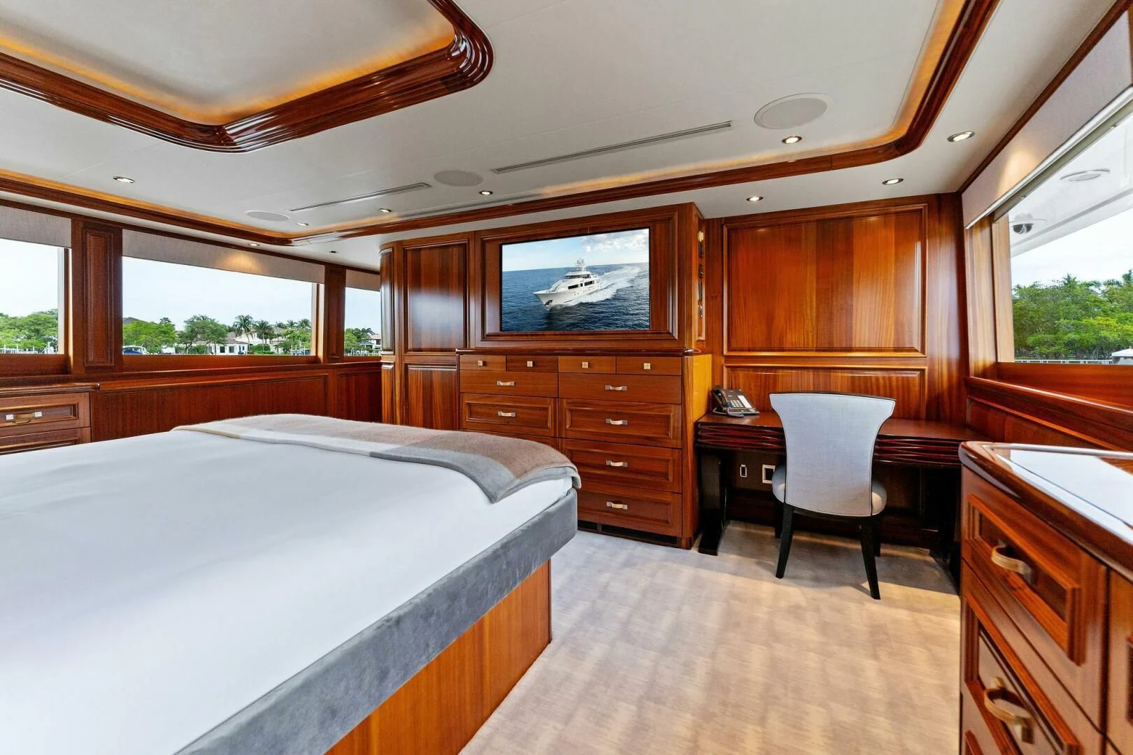 a bedroom with a bed and a chair aboard ANTARES Yacht for Sale