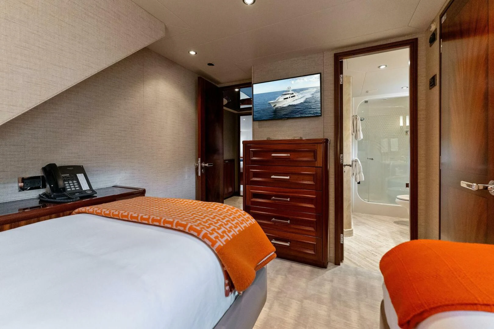 a hotel room with a bed and a television aboard ANTARES Yacht for Sale