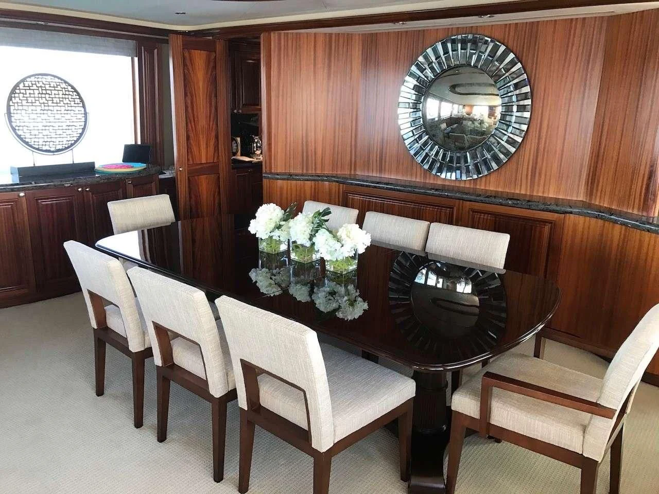 a dining table with chairs and a chandelier aboard ANTARES Yacht for Sale