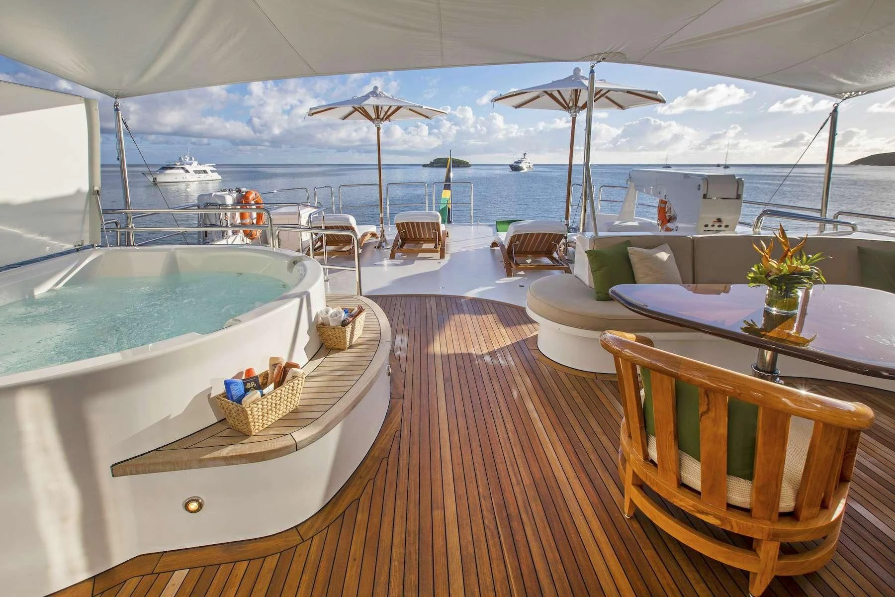 a large white tent with a table and chairs and umbrellas aboard ANTARES Yacht for Sale