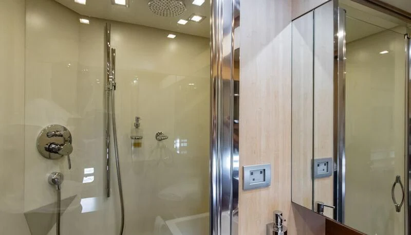a bathroom with a large glass shower aboard EL DISPARO Yacht for Sale