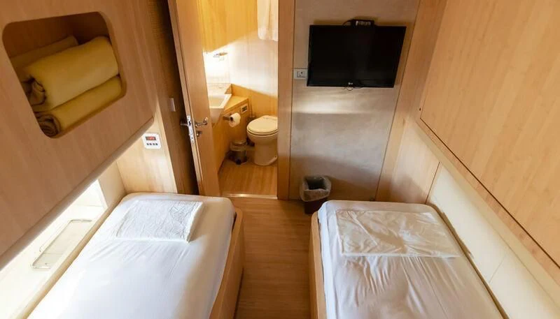a room with a bed and a television aboard EL DISPARO Yacht for Sale