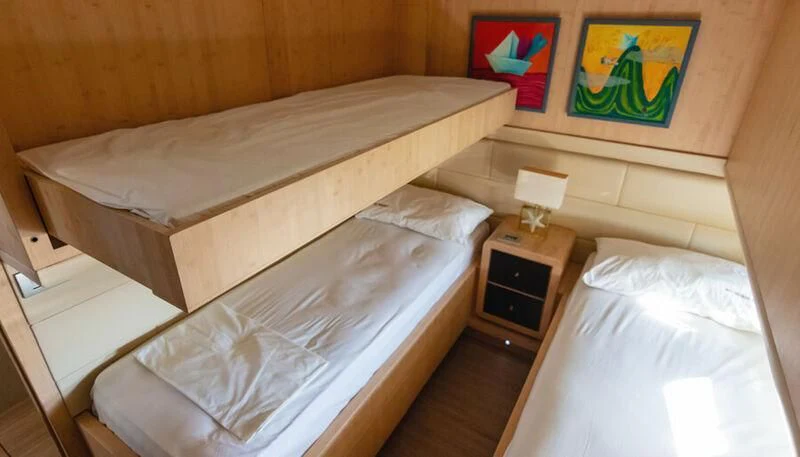 a room with two beds aboard EL DISPARO Yacht for Sale