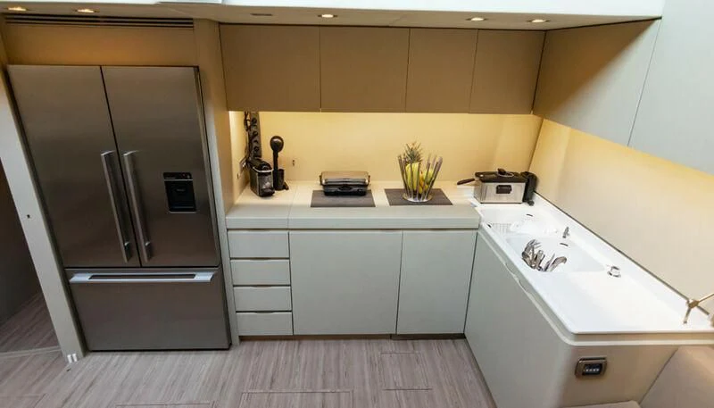 a kitchen with a refrigerator and stove aboard EL DISPARO Yacht for Sale