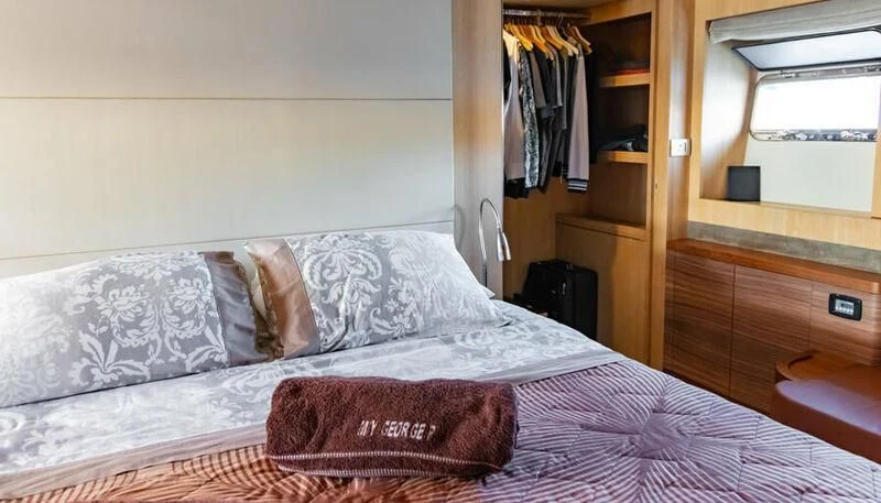 a bed with white sheets aboard EL DISPARO Yacht for Sale