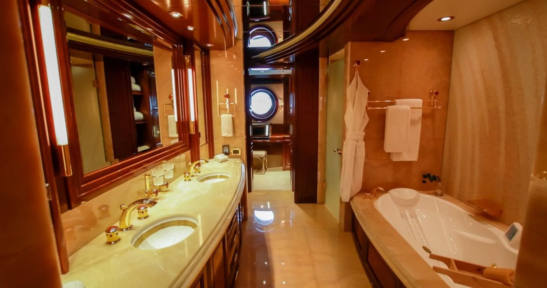 a bathroom with a tub sink and a mirror aboard BLUE MOON Yacht for Charter