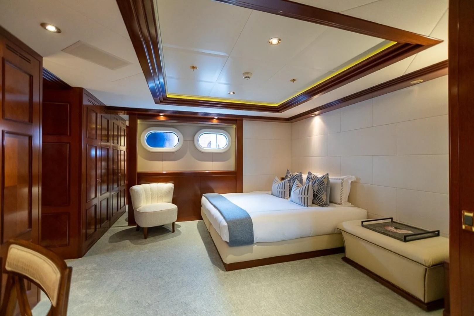 a room with a bed and a couch aboard BLUE MOON Yacht for Charter