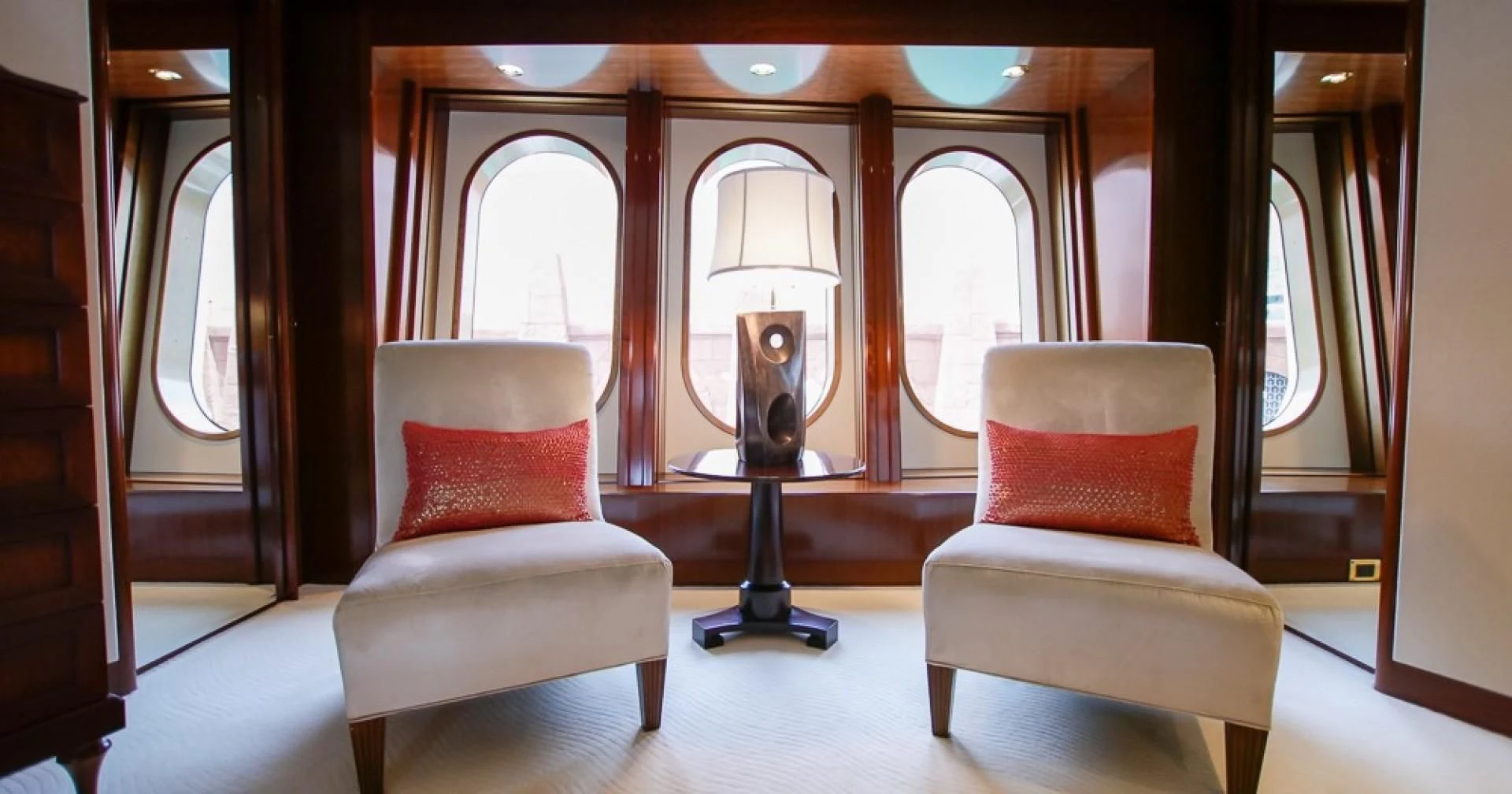 a room with a lamp and a chair aboard BLUE MOON Yacht for Charter