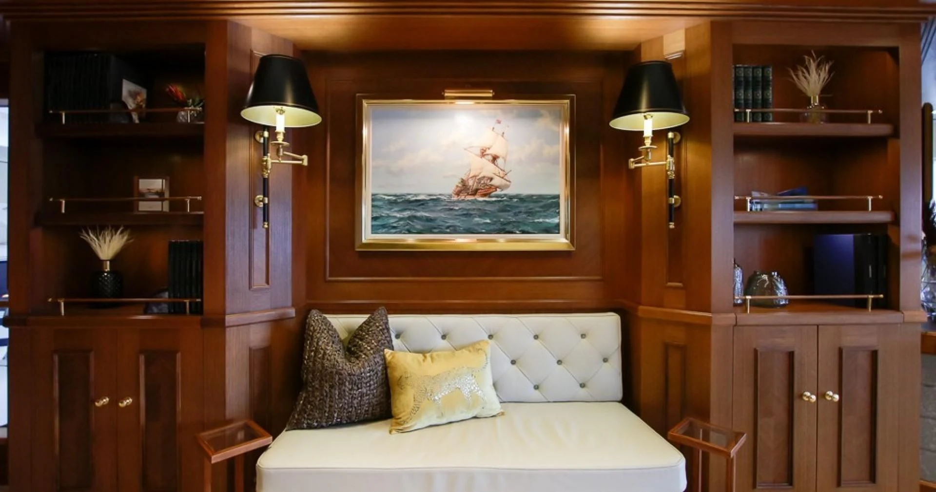 a bed with a painting on the wall aboard BLUE MOON Yacht for Charter