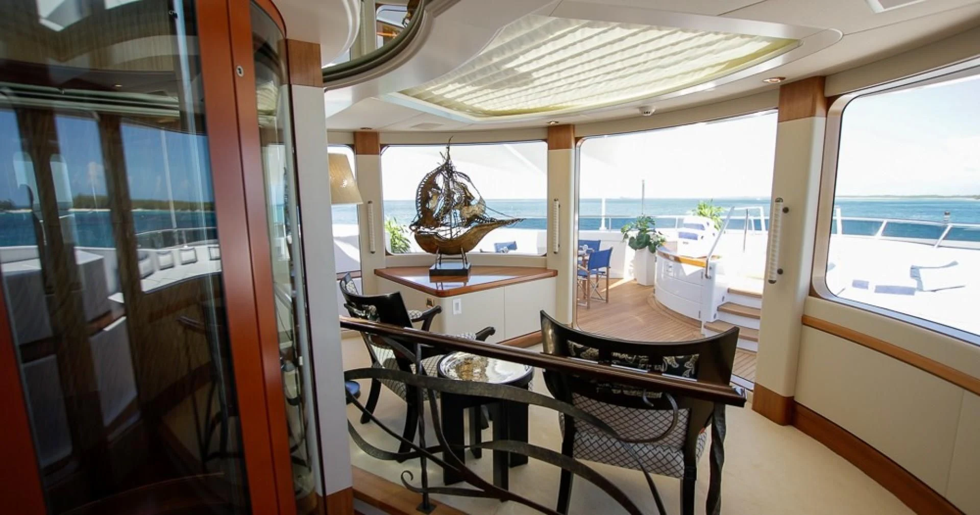 a room with a table and chairs aboard BLUE MOON Yacht for Charter