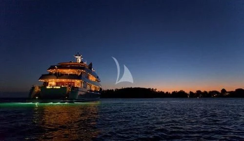 a boat in the water with a fire in the background aboard BLUE MOON Yacht for Charter