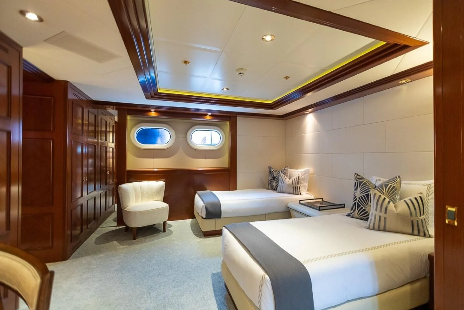 a room with a bed and a couch aboard BLUE MOON Yacht for Charter