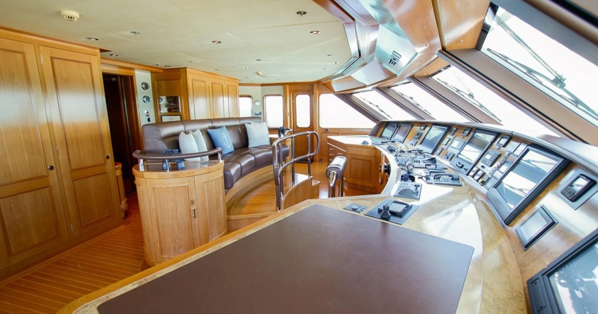 a living room with a kitchen and a couch aboard BLUE MOON Yacht for Charter