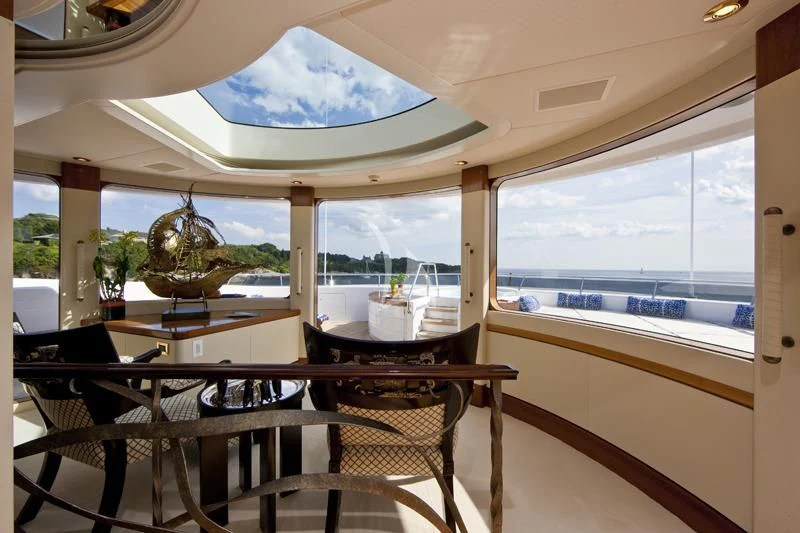 a room with a table and chairs aboard BLUE MOON Yacht for Charter