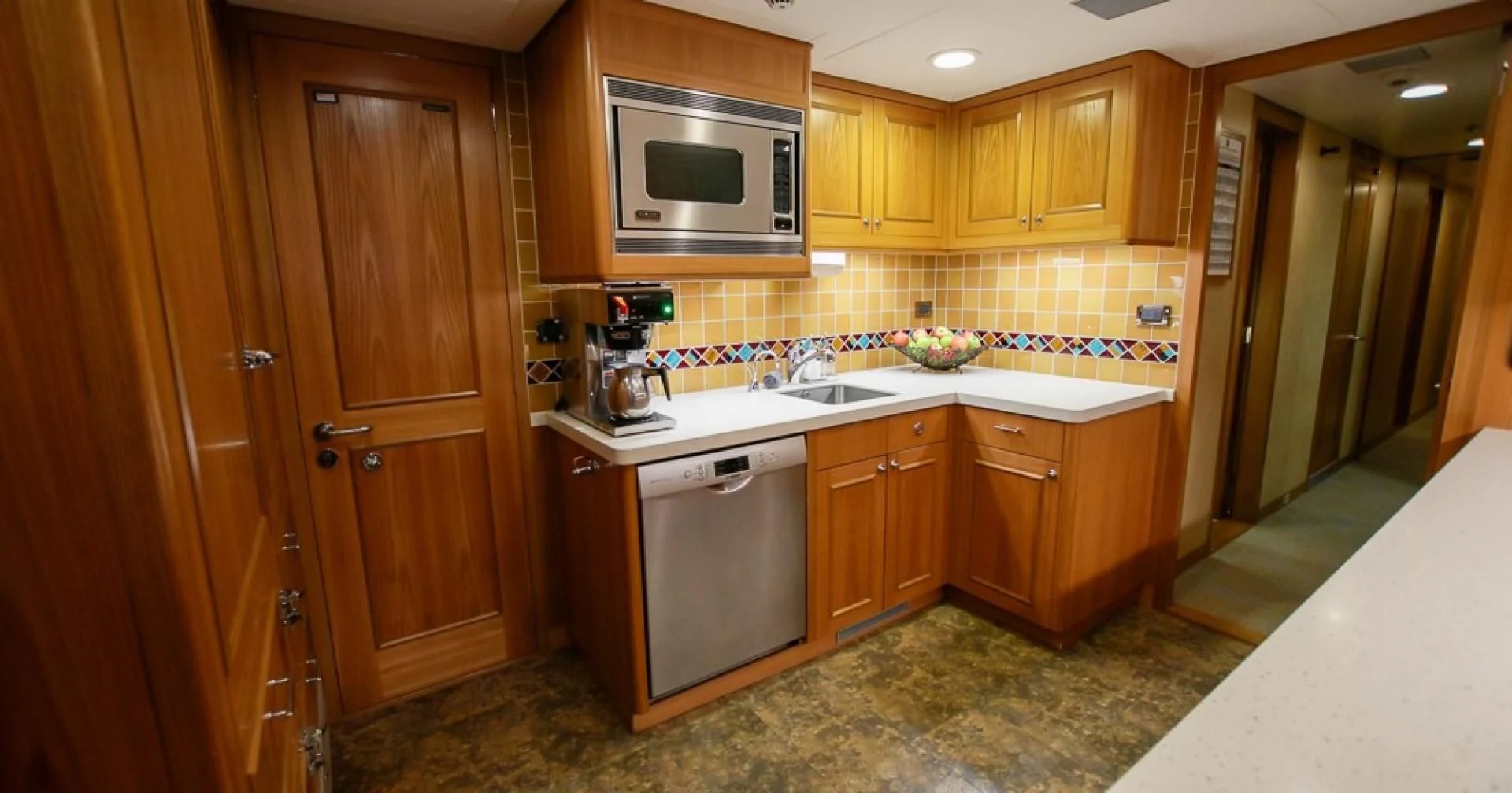 a kitchen with wooden cabinets aboard BLUE MOON Yacht for Charter
