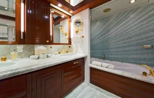 a bathroom with a bathtub and sink aboard BLUE MOON Yacht for Charter