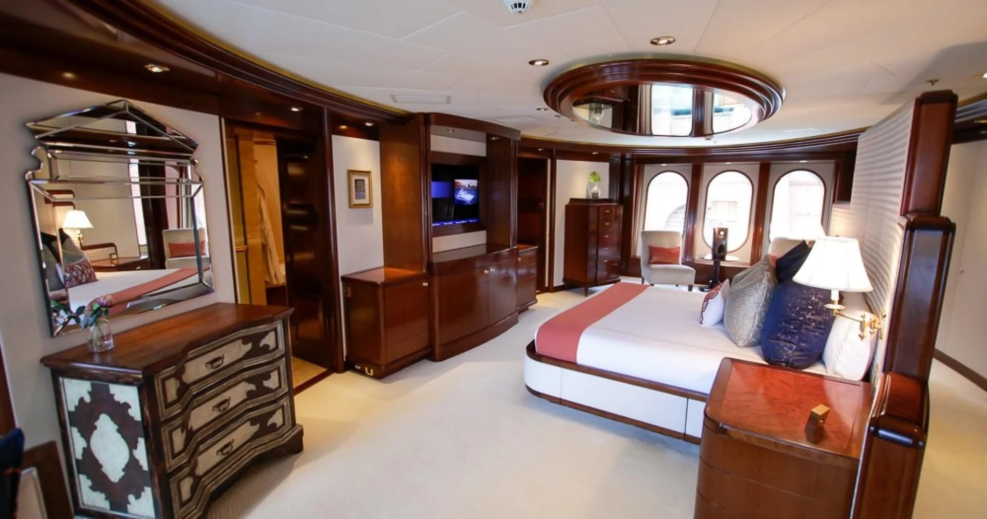 a large bedroom with a bed and a dresser aboard BLUE MOON Yacht for Charter