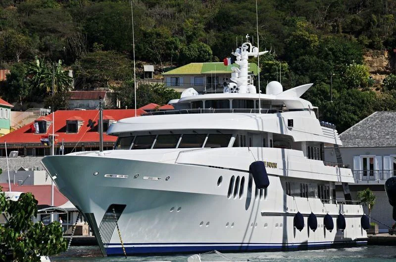 a boat docked in a harbor aboard BLUE MOON Yacht for Charter