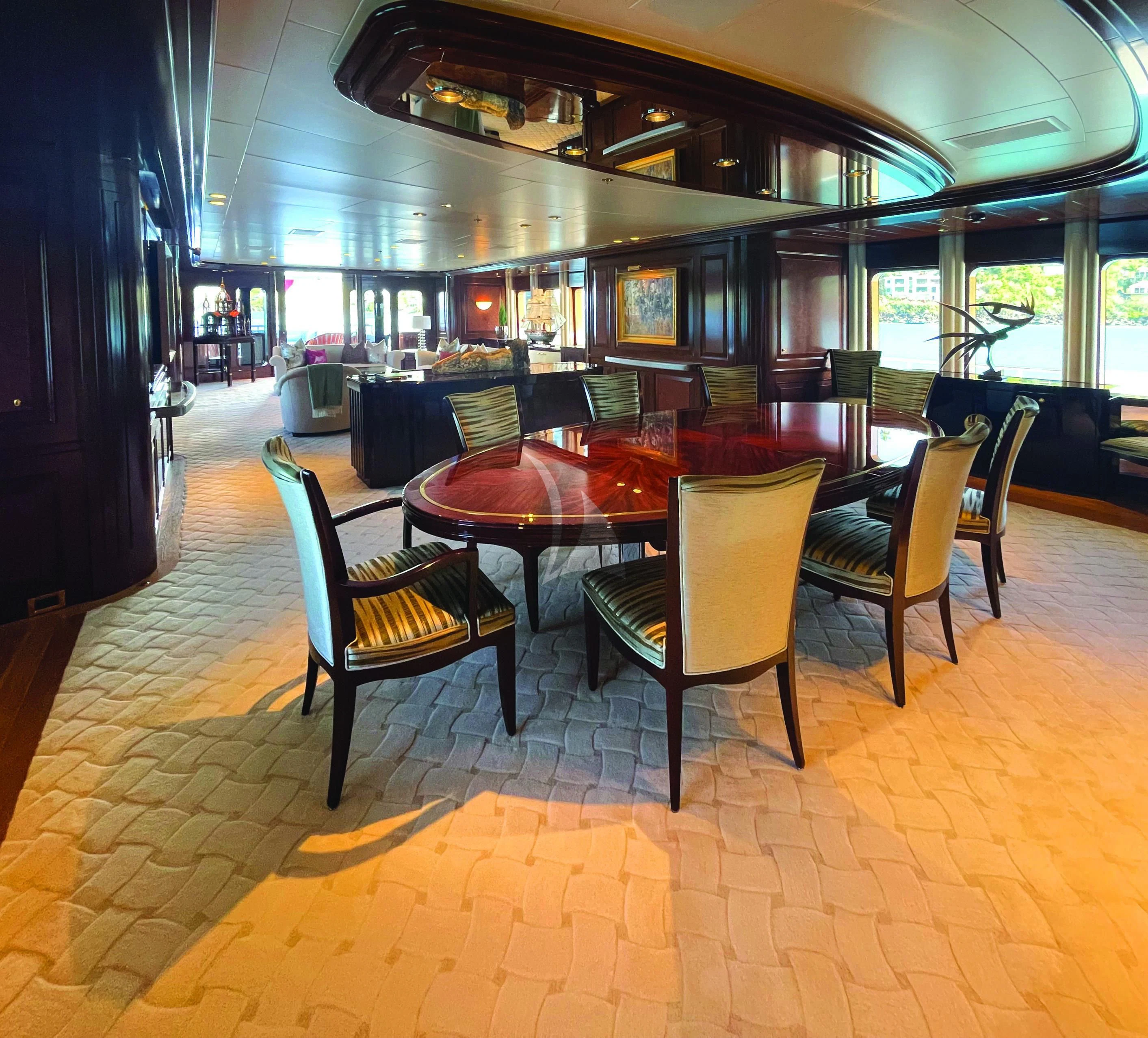 a table and chairs in a room aboard BLUE MOON Yacht for Charter