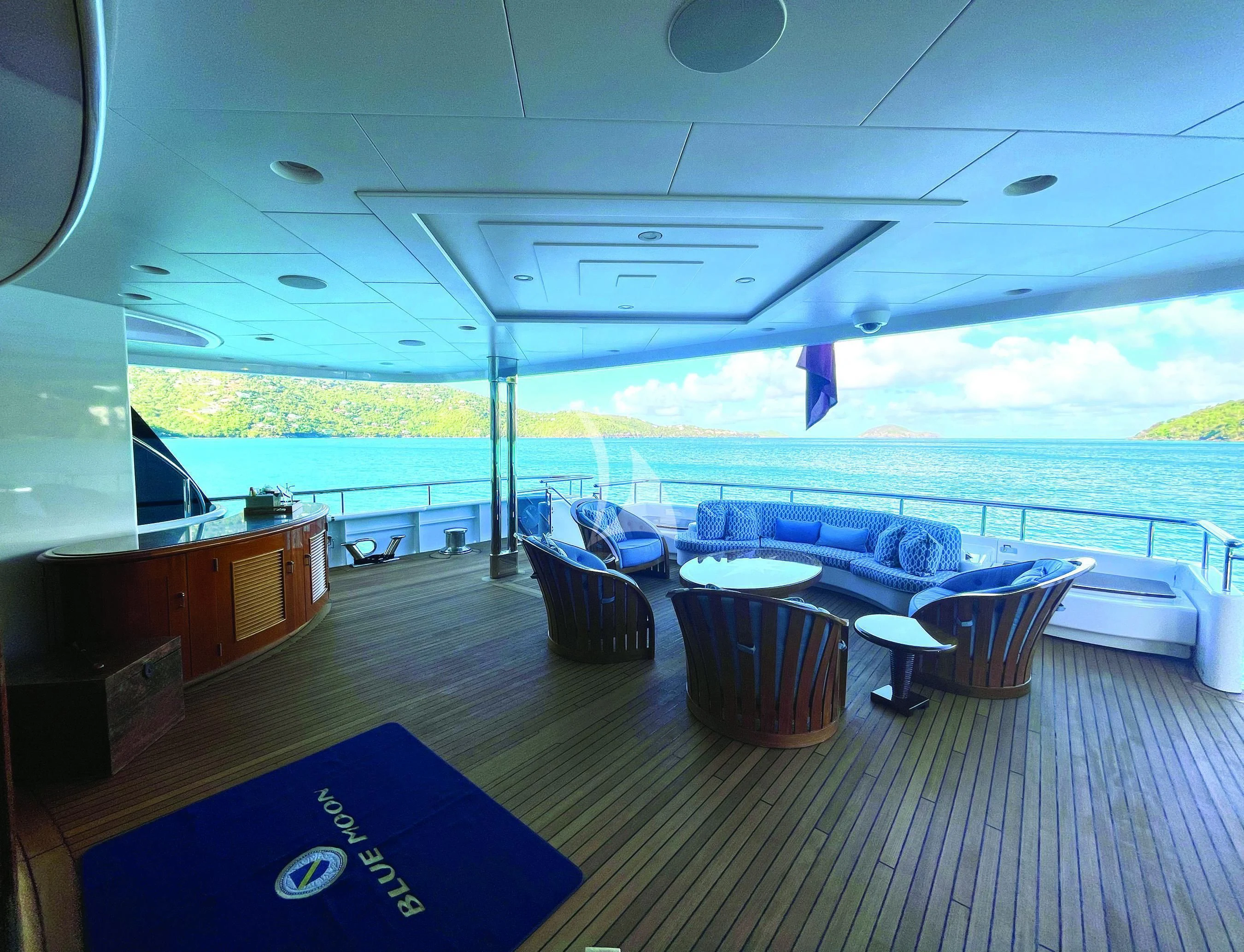 a room with a view of the ocean and the deck aboard BLUE MOON Yacht for Charter