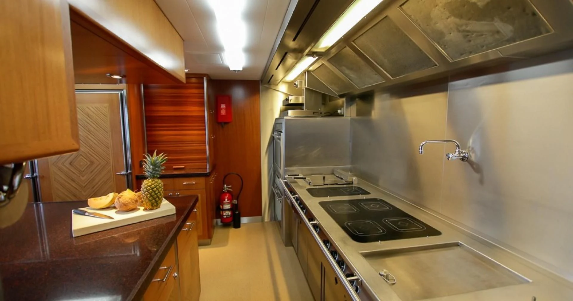 a kitchen with a stove and cabinets aboard BLUE MOON Yacht for Charter