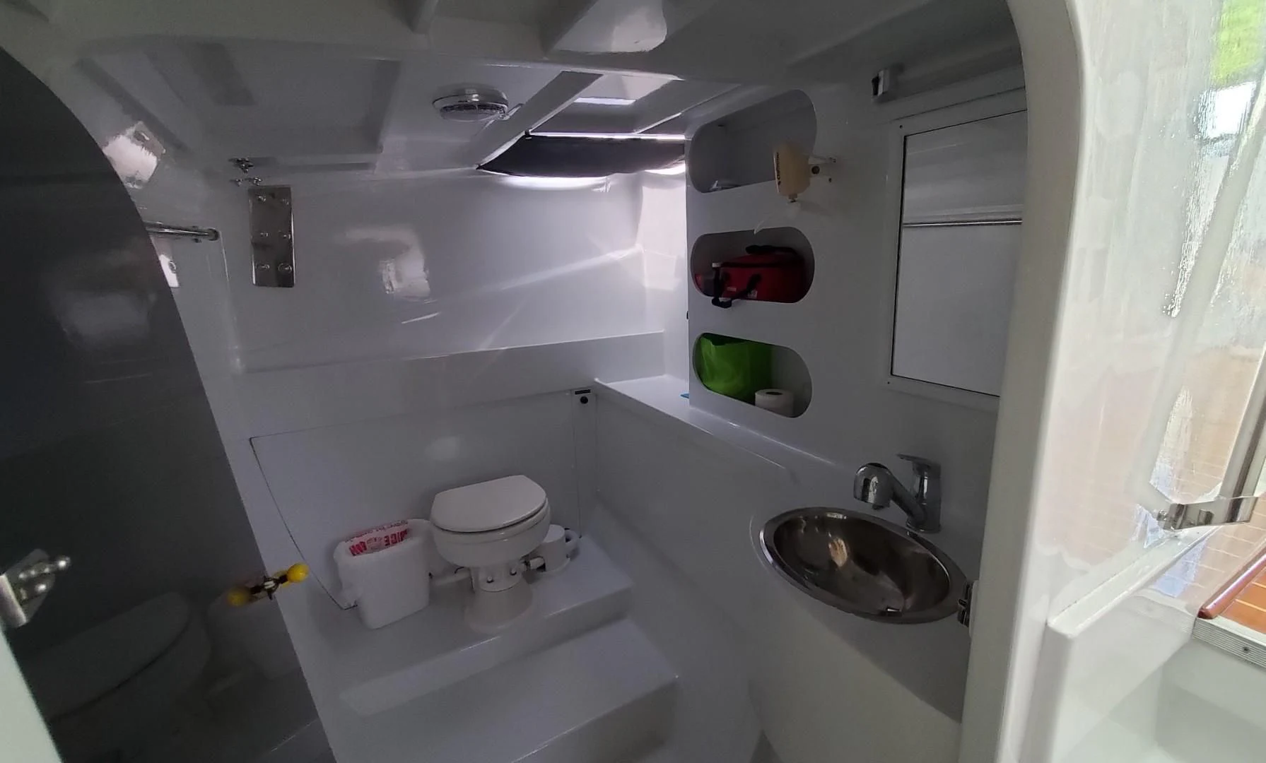 a small bathroom with a sink and toilet aboard BLUE MOON Yacht for Charter