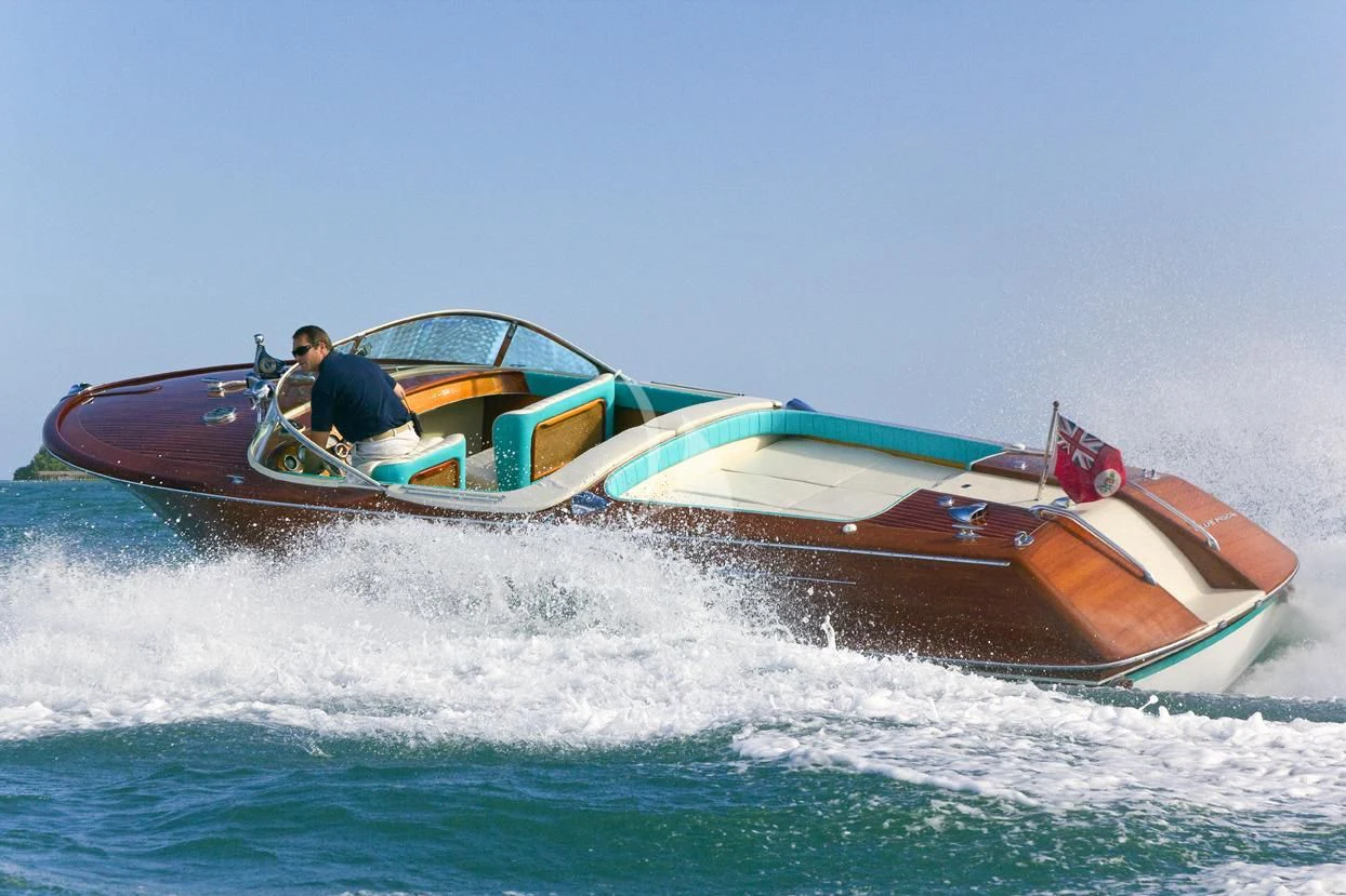 a man driving a boat aboard BLUE MOON Yacht for Charter
