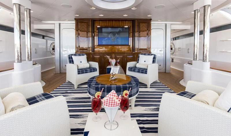 a room with a table chairs and a window aboard BLUE MOON Yacht for Charter