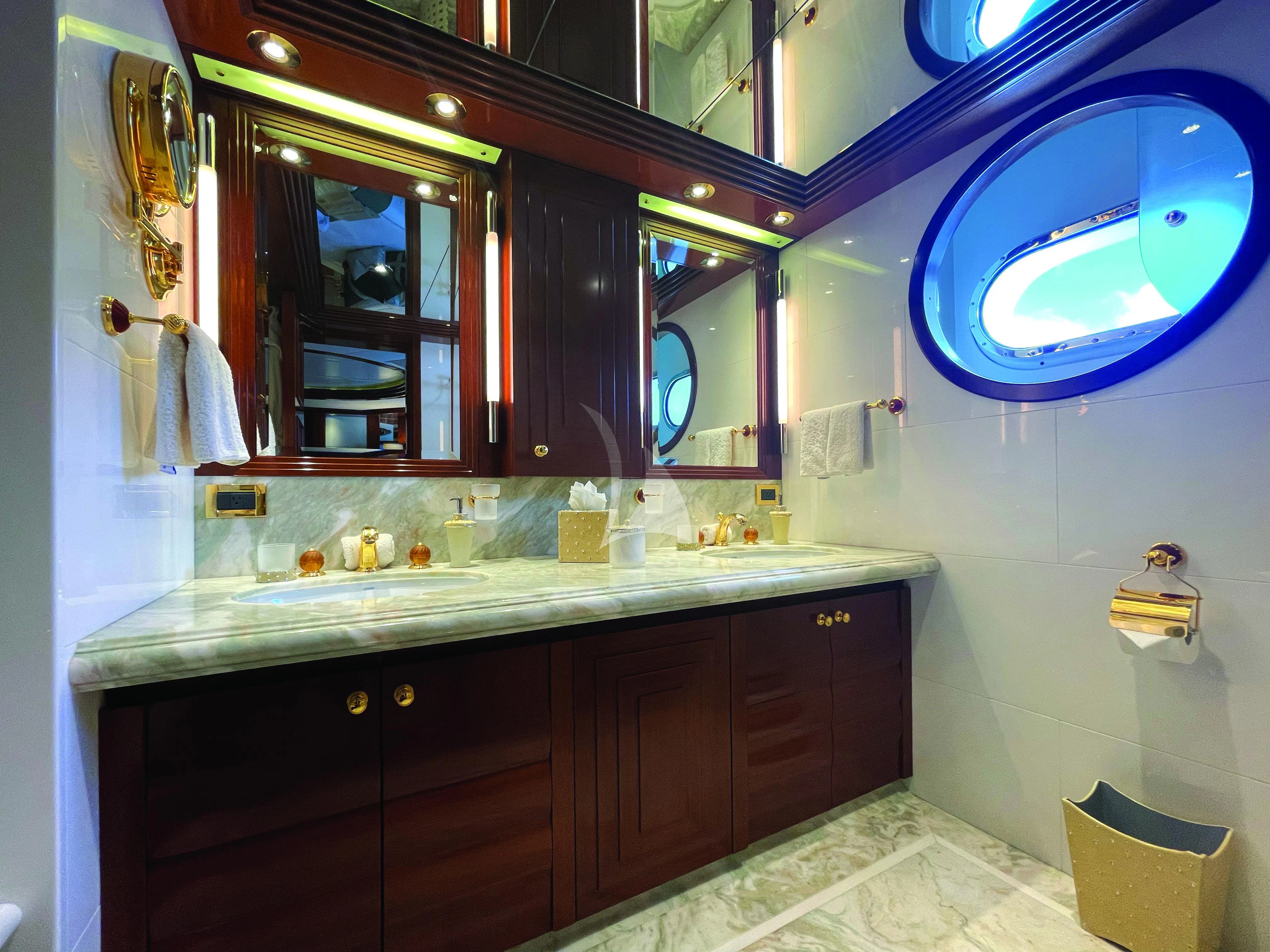 a bathroom with a large mirror aboard BLUE MOON Yacht for Charter