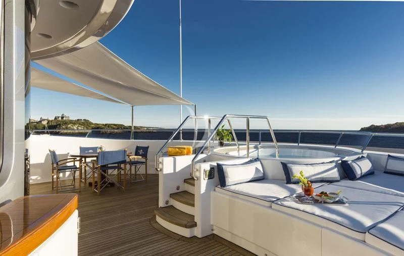 a room with a large deck and a pool aboard BLUE MOON Yacht for Charter