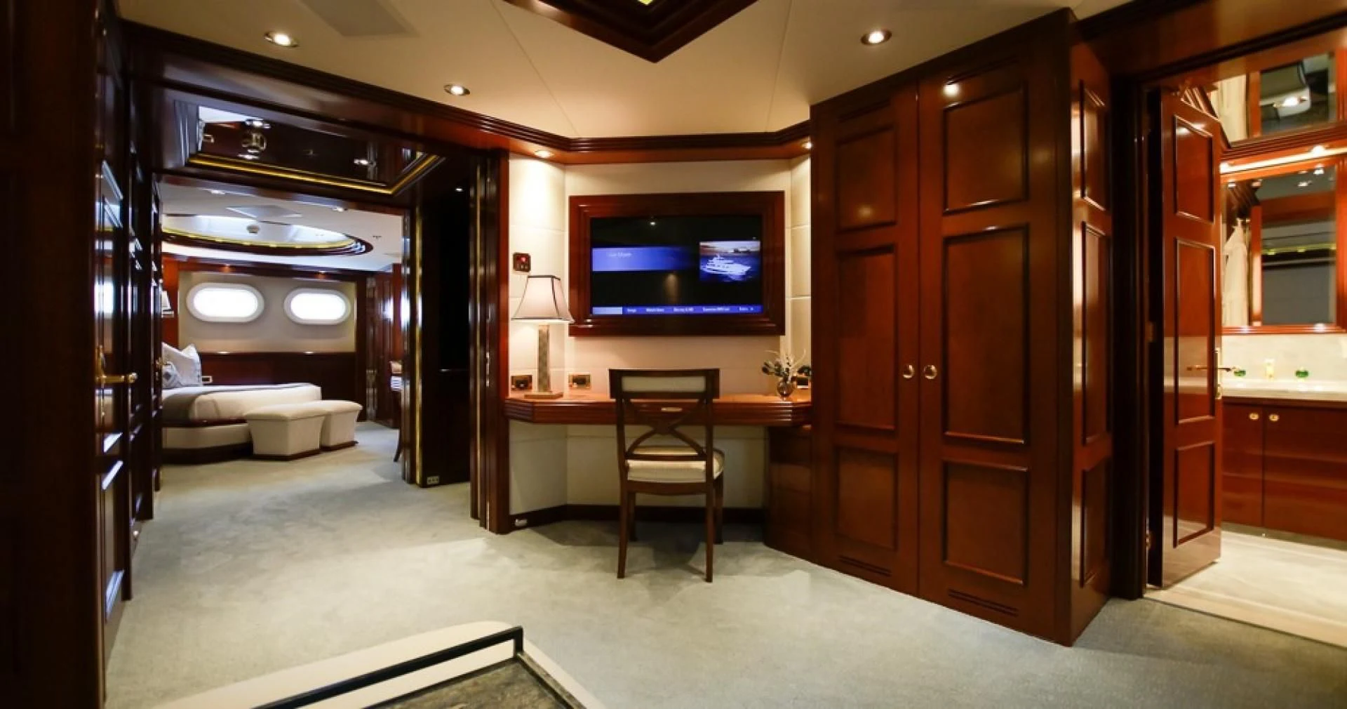 a room with a desk and a tv aboard BLUE MOON Yacht for Charter