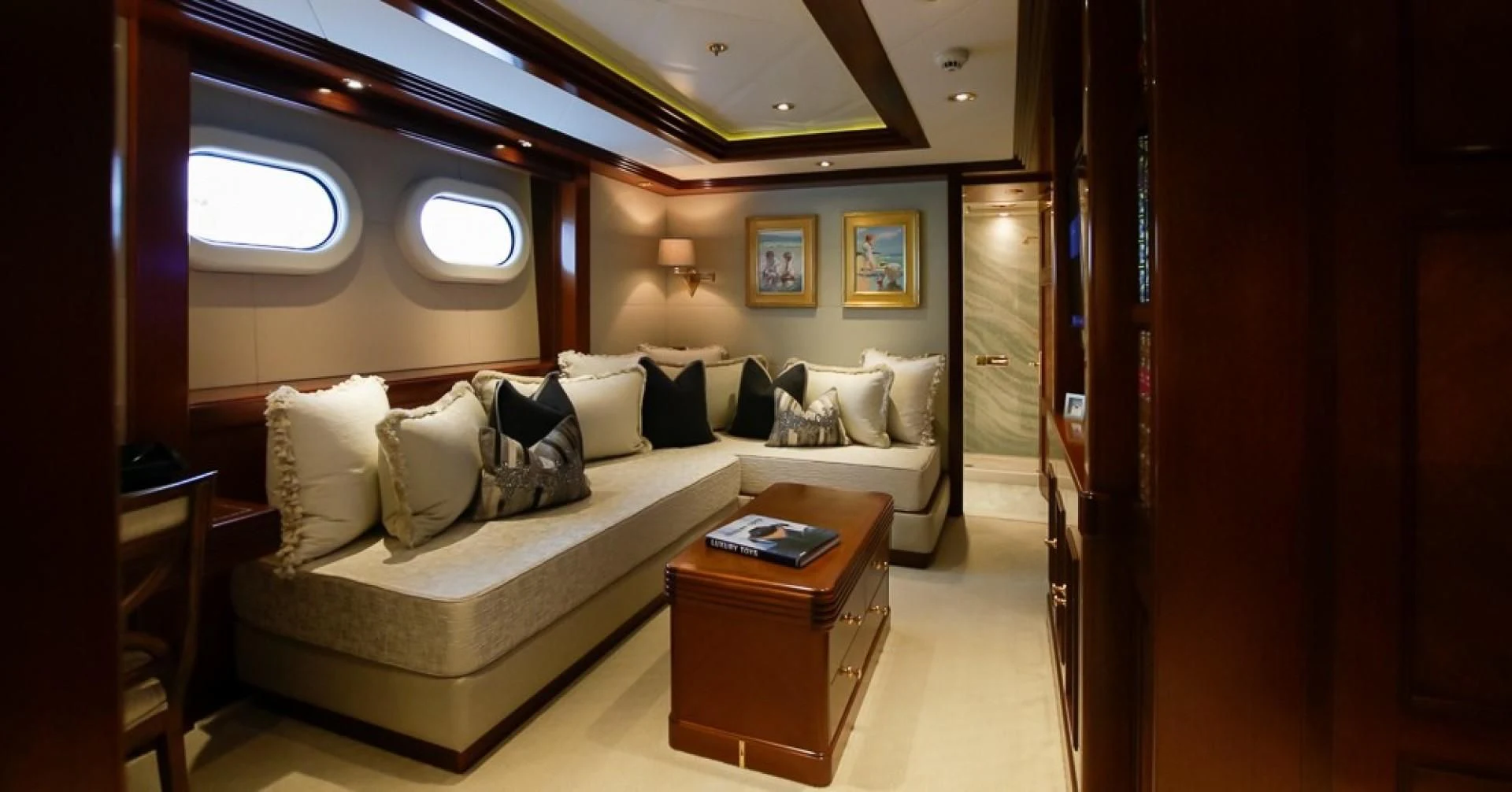 a living room with a couch and a coffee table aboard BLUE MOON Yacht for Charter